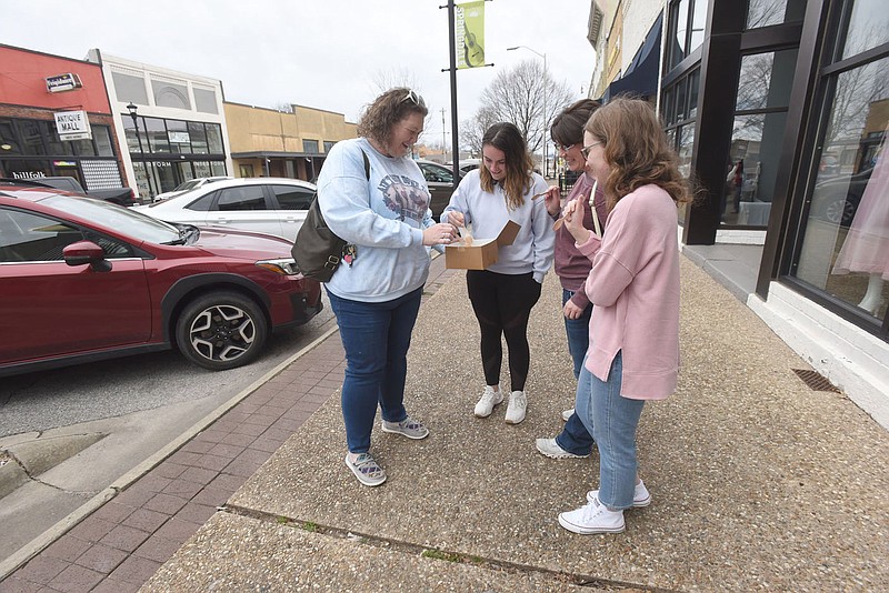 Jennifer Seigal (from left), Kalei Korte, Andrea Korte and Bailey Money share cake on Saturday Feb. 18 2023 they purchased in downtown Springdale from Shelby Lynn's Cake Shoppe on Emma Avenue. Their next stop was Big Sexy Food just down the street during their Saturday morning in downtown Springdale.
(NWA Democrat-Gazette/Flip Putthoff)