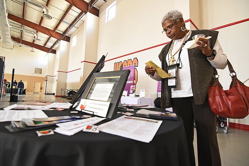 Damita Markes of Little Rock looks at a brochure for the Millie Brooks MicroLibrary while attending the Project 365 event Sunday at the Wrightsville City Hall Gymnasium.
(Arkansas Democrat-Gazette/Staci Vandagriff)