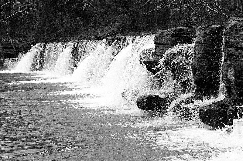 Randy Moll/Westside Eagle Observer
A Saturday afternoon trip south on Arkansas Highway 59 to Natural Dam yielded this photo. Natural Dam is easy to access and a parking area is adjacent to the falls. Natural Dam's waterfall tumbles about 8 feet over the rock barrier at the edge of the Ozark National Forest. It's one Arkansas waterfall visitors can see without even getting out of their cars. The natural waterfall on Mountain Fork Creek (just above Lee Creek) is about one-fourth mile west of Arkansas 59, some 45 miles south of Siloam Springs or 15 miles north of Van Buren, at the community of Natural Dam.