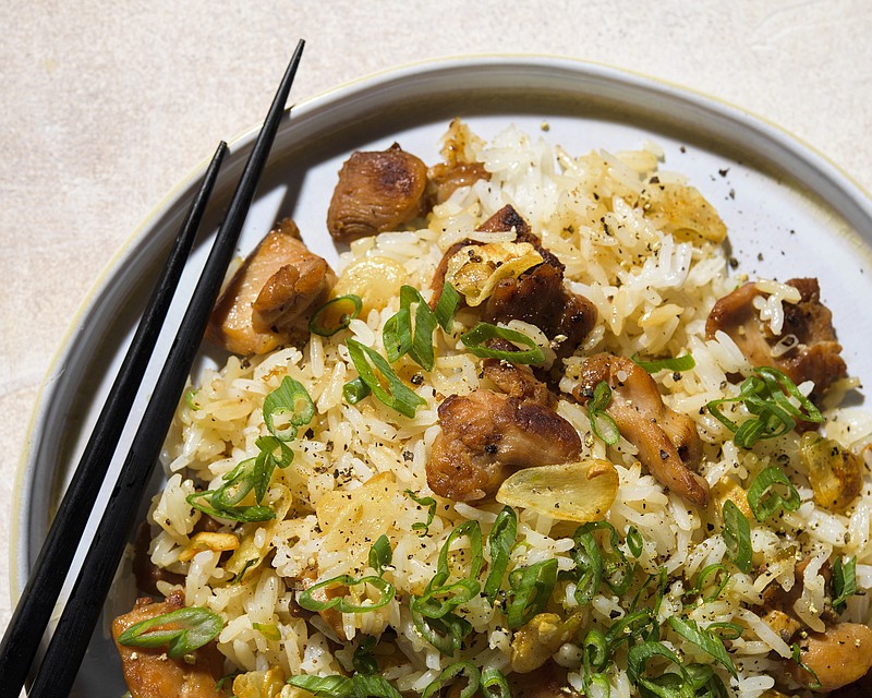 This image released by Milk Street shows a recipe for Garlic Fried Rice w/Chicken. (Milk Street via AP)
