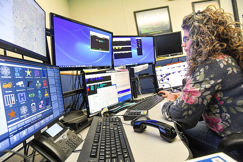 Angela McCabe, a dispatcher of 12 years, works Thursday at the Fort Smith Police Department 911 call center in downtown. At its meeting Wednesday, Sebastian County'a 911 Board discussed a plan to consolidate the three 911 call centers in the county’s system into one facility. Visit nwaonline.com/photo for today's photo gallery.

(River Valley Democrat-Gazette/Hank Layton)