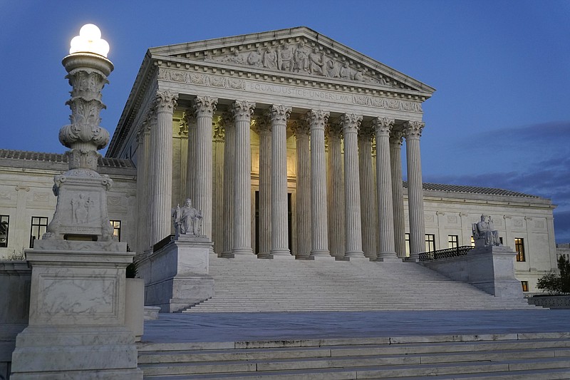 FILE - Light illuminates part of the Supreme Court building at dusk on Capitol Hill in Washington, Nov. 16, 2022.  (AP Photo/Patrick Semansky, File)