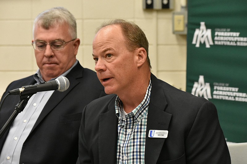 Mark Tiner, a loan officer from Monticello, makes comments about agriculture lending as Sam E. Angel II of the Arkansas Agriculture Board listens Tuesday during a farm bill listening session at the University of Arkansas at Monticello. (Pine Bluff Commercial/I.C. Murrell)