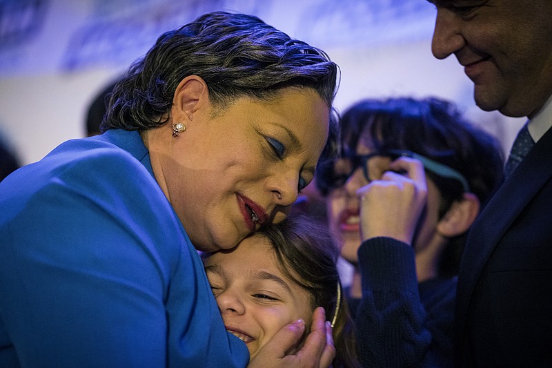 Congresswoman-elect Jennifer McClellan, D-Va., hugs her daughter Samantha Mills at her election party in Richmond, Va., after winning the seat for Virginia's 4th Congressional District on Tuesday, Feb. 21, 2023. McClellan prevailed over right-wing Republican nominee Leon Benjamin.  (AP Photo/John C. Clark)