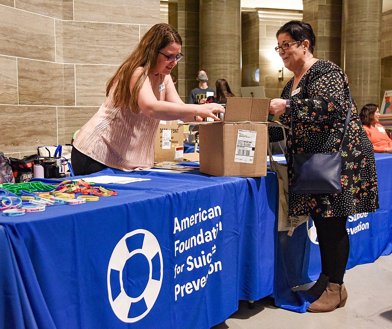 Julie Smith/News Tribune photo: 
Lauren Ross, left, and Pat Harkins prepare to distribute information about the American Foundation for Suicide Prevention Missouri Chapter Wednesday during a visit to the Capitol for a rally and visit with state legislators. Ross is a board member and advocate and chair of Advocacy Day at the Missouri Capitol. Harkins is also a board member and on her way to see legislators to disseminate information about the program and the need for funding for it.