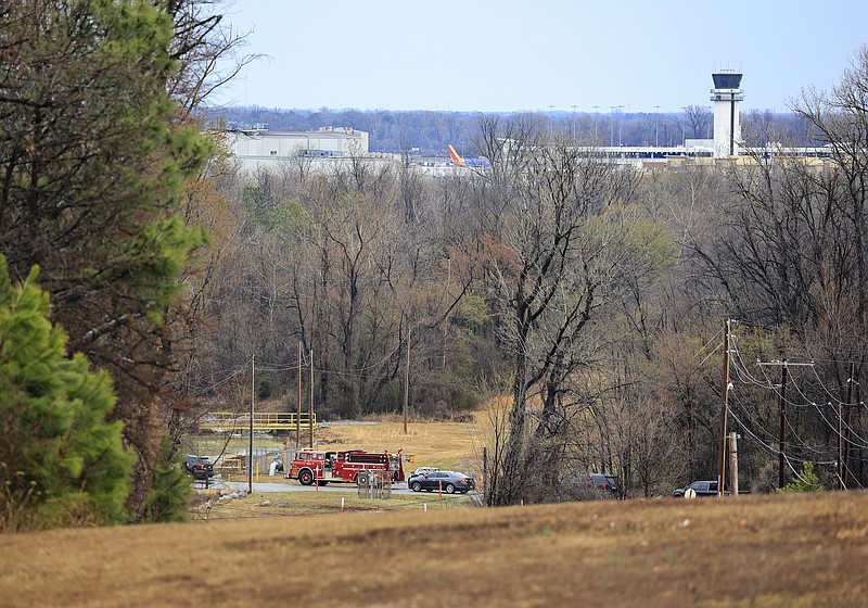 Emergency vehicles appear near the location where a small aircraft crashed while taking off from the Bill and Hillary Clinton National Airport in Little Rock on Wednesday. - Staton Breidenthal/Arkansas Democrat-Gazette
