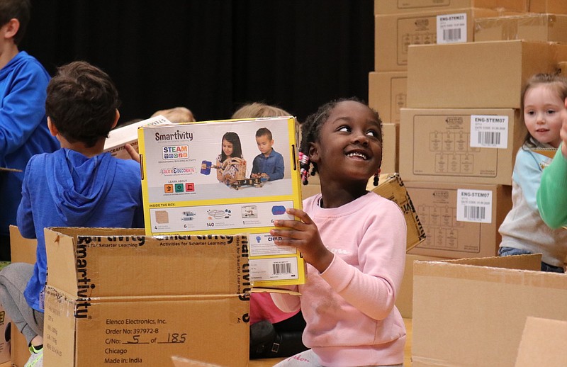 Anna Campbell/News Tribune
Kindergarten student Asiah Summers unboxes an engineering kit in the Moreau Heights Elementary School gym Thursday.