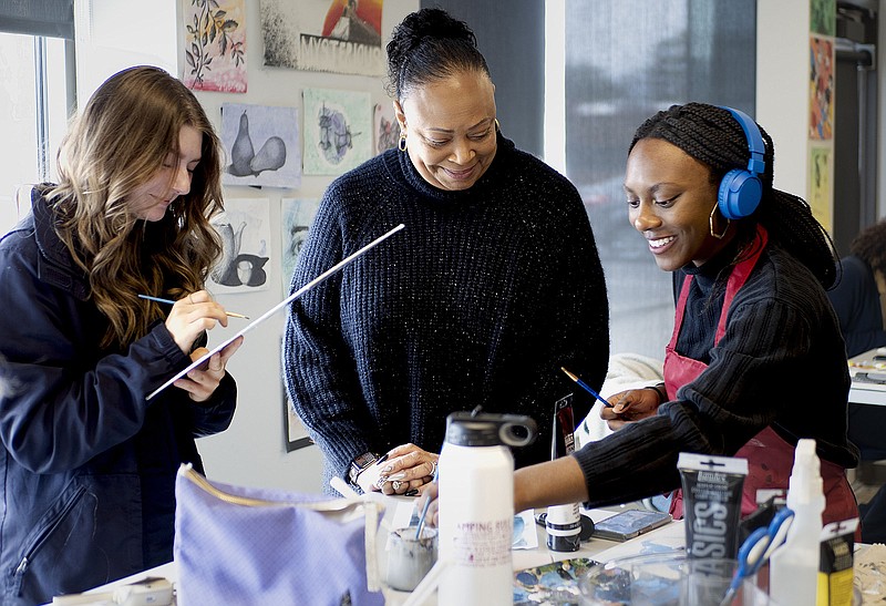 Olivia Summerhill (from left) works on a painting as art teacher Jeri Dockery helps Olivia Patterson with a painting Friday at the Rogers Haas Hall campus. Haas Hall is opening a Fort Smith campus. Visit nwaonline.com/photos for today's photo gallery.

(River Valley Democrat-Gazette/Charlie Kaijo)