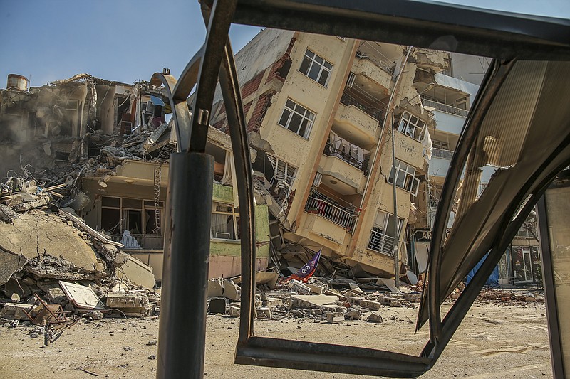 A destroyed building leans on a neighbouring house following the earthquake in Samandag, southern Turkey, Wednesday, Feb. 22, 2023. Survivors of the earthquake that jolted Turkey and Syria 15 days ago, killing tens of thousands of people and leaving hundreds of thousands of others homeless, dealt with more trauma and loss Tuesday after another deadly quake and aftershocks rocked the region. (AP Photo/Emrah Gurel)