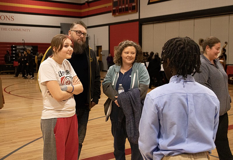 Josh Cobb/JeffersonCity News Tribune. Lewis And Clark Middle School hosted a Black History live museum on Thursday evening. Aiden Hite (right) tells Ruby Abbott, Steve Abbott, and Ashley Richards about the life of Martin Luther King JR.