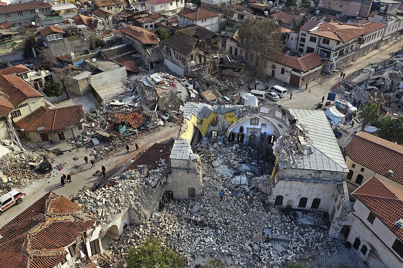 Ciudadanos turcos caminan el sábado 11 de febrero de 2023 frente a la histórica mezquita Habib Najjar, la cual quedó destruida durante un devastador terremoto, en la ciudad de Antioquía, Turquía. (AP Foto/Hussein Malla)