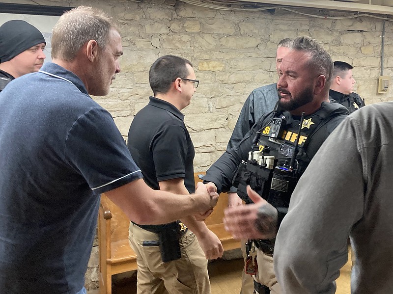 Democrat photo/Garrett Fuller — Presiding Commissioner Joe Lutz, left, shakes hands with road Sgt. Aaron Bishop Thursday (Feb. 23, 2023,) after commissioners voted to proceed with planning the new sheriff's office facility at the Moniteau County Courthouse.