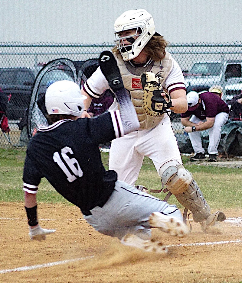 Randy Moll/Westside Eagle Observer
Siloam Springs' Bode Butler slides across home plate ahead of the throw to Gentry catcher Crafton Beeler during play between the Panthers and the Pioneers in Gentry on Feb. 21.