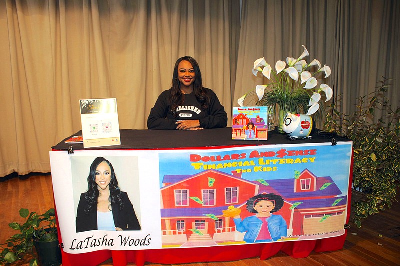 Photo By: Michael Hanich
Author LaTasha Woods poses behind her desk at Fairview Elementary School.