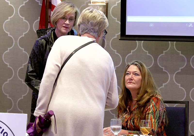 Shawnee Cooper, right, speaks to members of the Rotary Club of Hot Springs National Park following her presentation on Wednesday. – Photo by Courtney Edwards of The Sentinel-Record