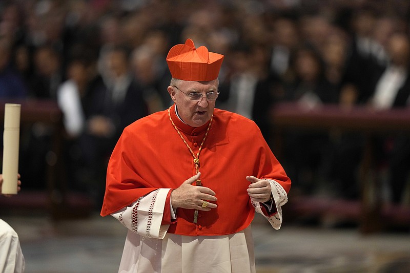 FILE - Cardinal Arthur Roche walks after receiving the red three-cornered biretta hat from Pope Francis during a consistory inside St. Peter's Basilica, at the Vatican, on Aug. 27, 2022. Pope Francis approved a new decree published Tuesday, Feb. 21, 2023, repeating that the Holy See must sign off on bishops’ decisions to designate new parish churches for the Latin Mass or to let newly ordained priests celebrate the old rite. The decree states that the Vatican’s liturgy office, headed by British Cardinal Arthur Roche, is responsible for granting such approvals. (AP Photo/Andrew Medichini)