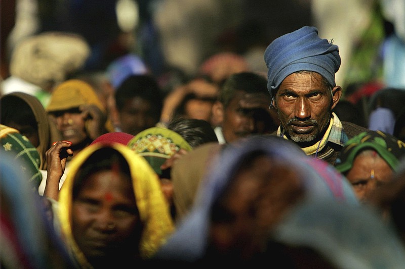 FILE - Members of the audience listen to a speaker at a rally organized by National Conference of Dalit Organisations in New Delhi, India, Sunday, Dec. 5, 2005. Dalits, who belong to the lowest of castes according to the Indian caste system, came from different parts of India to participate in a rally to mark World Dignity Day. Caste is an ancient system of social hierarchy based on one’s birth that is tied to concepts of purity and social status. While the definition of caste has evolved over the centuries, under Muslim and British rule, the suffering of those at the bottom of the caste pyramid – known as Dalits, which in Sanskrit means broken — has continued. (AP Photo/Gurinder Osan, File)