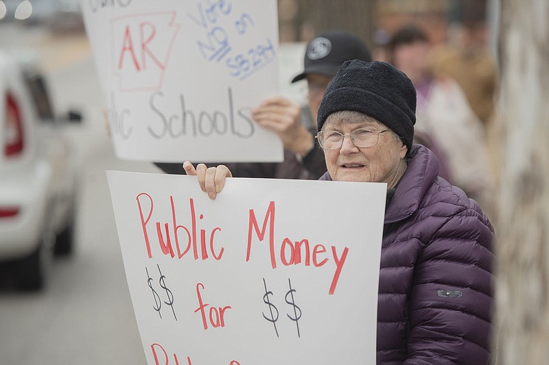 Laura Villegas of Springdale holds a sign along with public school teachers and supporters Saturday Feb. 25, 2023 at the Washington County Courthouse in Fayetteville.They gathered to express opposition to the recently proposed LEARNs Act. Villegas was a public school teacher for 27 years. The Northwest Arkansas Young Democrats hosted the non-partisan rally and call to action in opposition to the proposed LEARNs Act and in support of SB149. Around fifty people attended the protest.  Visit nwaonline.com/photo for today's photo gallery.   (NWA Democrat-Gazette/J.T. Wampler)