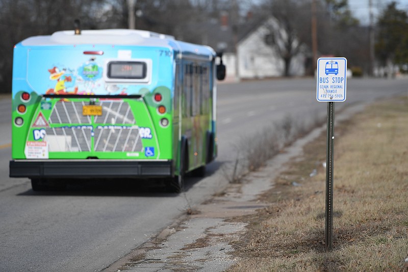 An Ozark Regional Transit bus passes a bus stop Friday, Dec. 30, 2022, on School Avenue in south Fayetteville. (NWA Democrat-Gazette/Andy Shupe)