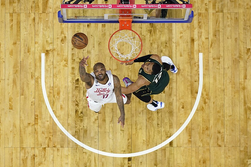 Boston Celtics' Jaylen Brown, right, goes up to shoot against Philadelphia  76ers' Paul Reed during the first half of Game 4 in an NBA basketball  Eastern Conference semifinals playoff series, Sunday, May