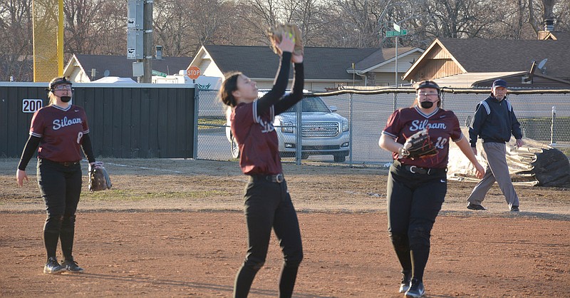Graham Thomas/Herald-Leader
Siloam Springs senior pitcher Hannah Mather (middle) secures a catch during an Arkansas Activities Association benefit game against Lincoln at La-Z-Boy Park on Feb. 23.