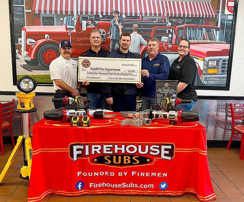 Submitted photo
Highfill fire chief Cody Wynne (left), Bobby Stevens (Firehouse Subs franchisee), former Highfill fire chief Gene Holland and Doug Burnett and Stephanie Chase of Firehouse Subs pose for a photo with the emergency extrication equipment donated to the Highfill Fire Department by Firehouse Subs on Feb. 22 at the Firehouse Subs location in Bentonville.