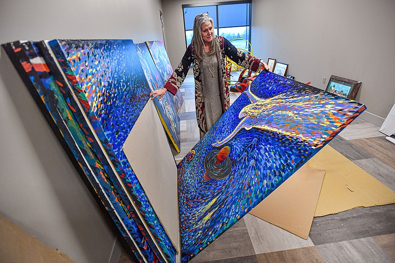 Elizabeth McClain, chief wellness officer for the Arkansas Colleges of Health Education, previews on Wednesday art that will be on display at the school’s soon-to-open Health and Wellness Center in Fort Smith. Visit nwaonline.com/photo for today’s photo gallery.

(River Valley Democrat-Gazette/Hank Layton)