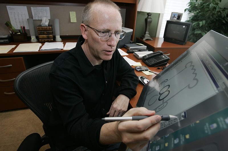 FILE - Scott Adams, creator of Dilbert, works on his comic strip in his studio in in Dublin, Calif., on Oct. 26, 2006. Syndication company Andrews McMeel announced they were severing ties with Adams after he made comments about race on his YouTube show, &#x201c;Real Coffee with Scott Adams.&#x201d; (AP Photo/Marcio Jose Sanchez, File)