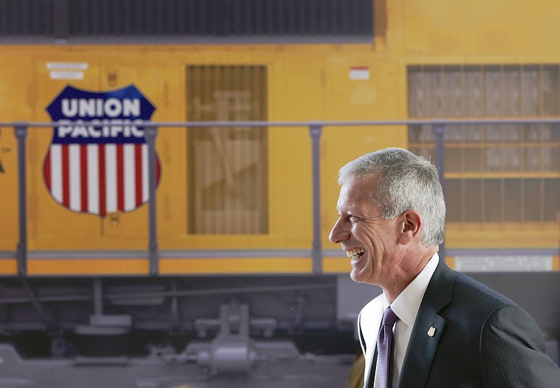 FILE- Union Pacific Chairman, President, and CEO Lance Fritz smiles after a news conference at the Durham Museum in Omaha, Neb., on Feb. 17, 2017. Union Pacific announced plans Sunday, Feb. 26, 2023, to replace Fritz later this year after a hedge fund that holds a $1.6 billion stake in the railroad went public with its concerns about his leadership. (AP Photo/Nati Harnik, File)
