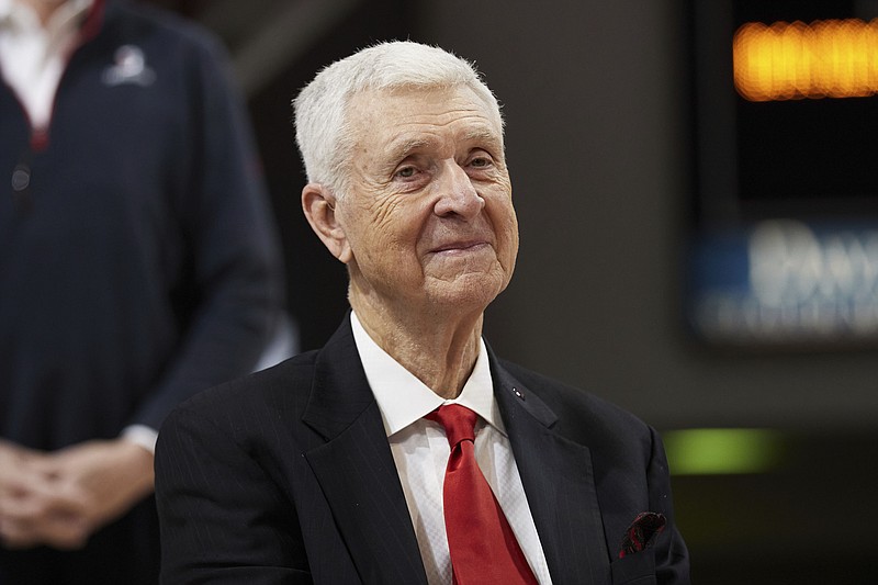 FILE - Former Davidson basketball player, coach, and Athletic Director, and former Virginia coach, Terry Holland, smiles during a ceremony to retire his jersey number 42 following an NCAA college basketball game between LaSalle and Davidson on Sunday, Jan. 30, 2022, in Davidson, N.C. Terry Holland, who elevated Virginia basketball to national prominence during 16 seasons as coach and later had a distinguished career as an athletic administrator, has died, the school announced Monday, Feb. 27, 2023. He was 80. (AP Photo/Brian Westerholt, File)