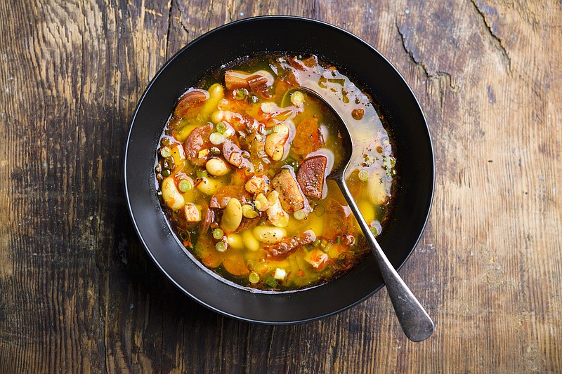 This image released by Milk Street shows a recipe for Spanish Chorizo, Ham and White Bean Stew. (Milk Street via AP)