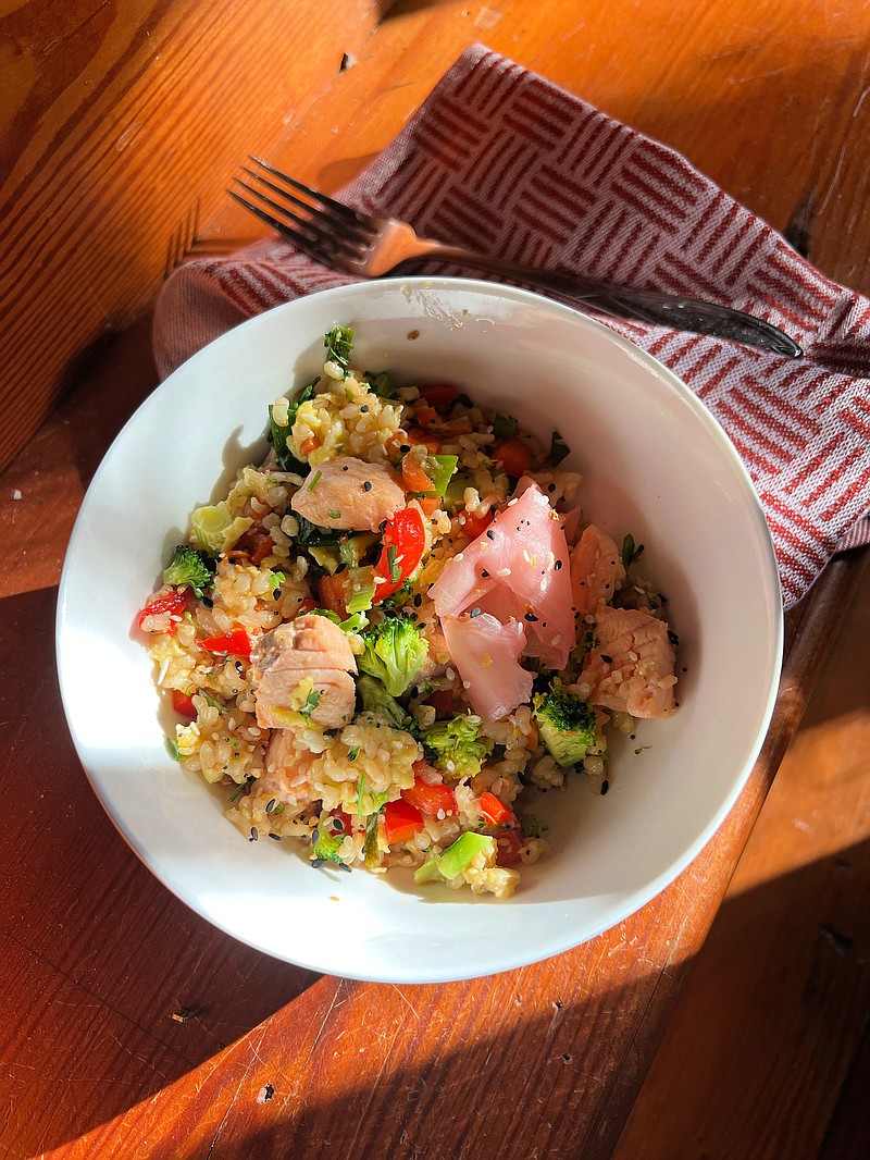 Leftover rice paired with cooked salmon and chopped veggies means a healthful dinner in a flash. (Gretchen McKay/Pittsburgh Post-Gazette/TNS)