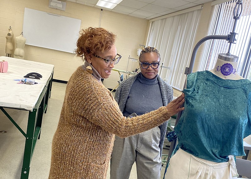 Nina Lyon-Bennett, Ph.D, (left) assistant dean for academics for the University of Arkansas at Pine Bluff School of Agriculture, Fisheries and Human Sciences, speaks with Havilland Ford, a Merchandising, Textiles and Design student, about Ford's designs. (Special to The Commercial/University of Arkansas at Pine Bluff)