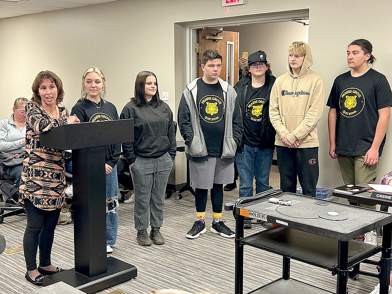 Lynn Kutter/Enterprise-Leader
Donna Mitchell, Prairie Grove High School teacher, left, introduces members of the junior high Quiz Bowl team to the school board during its Feb. 21 meeting. Members at the meeting: Rylee Lane, Delaney Ake, Jackson McCratic, Andrew Moore, Elijah Sugg and  Dominique Fitts. Not pictured are GT coordinator Melanie Nations, Logan Cain, Kaleb Bronson, Eber Barraza and Gus Andrews. The team came in third place in district, qualified for state in DeQueen and then finished in fourth place at state. Team member Logan Cain received All-State recognition.