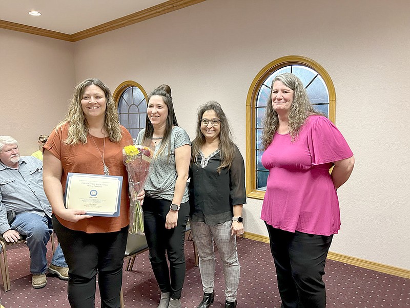 Rachel Dickerson/McDonald County Press Pineville City Clerk Melissa Ziemianin, left, accepts a certificate from Sylvia Dearing, Peggy England and Cindy Jennings at the Pineville Board of Aldermen meeting Tuesday night.