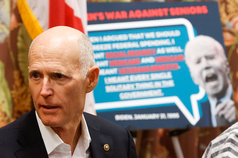 TNS
U.S. Sen. Rick Scott speaks to community leaders and Florida seniors during a roundtable discussion at the Sun Towers Retirement Community on Friday in Sun City Center. Behind him is a poster that reads: "Biden's war against seniors."