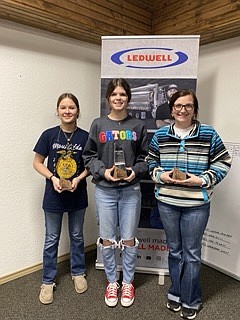 The winners of the Girl Power to the Max STEM event pose with their awards after the competition Wednesday, March 1, 2023, at Ledwell in Texarkana, Texas. From left are People's Choice winner Emily Lewis of Mount Ida, Ark.; and first-place recipients Mallory Abercrombie of Foreman, Ark., and Kinlee Stivers of Horatio, Ark. (Staff photo by Sharda James)