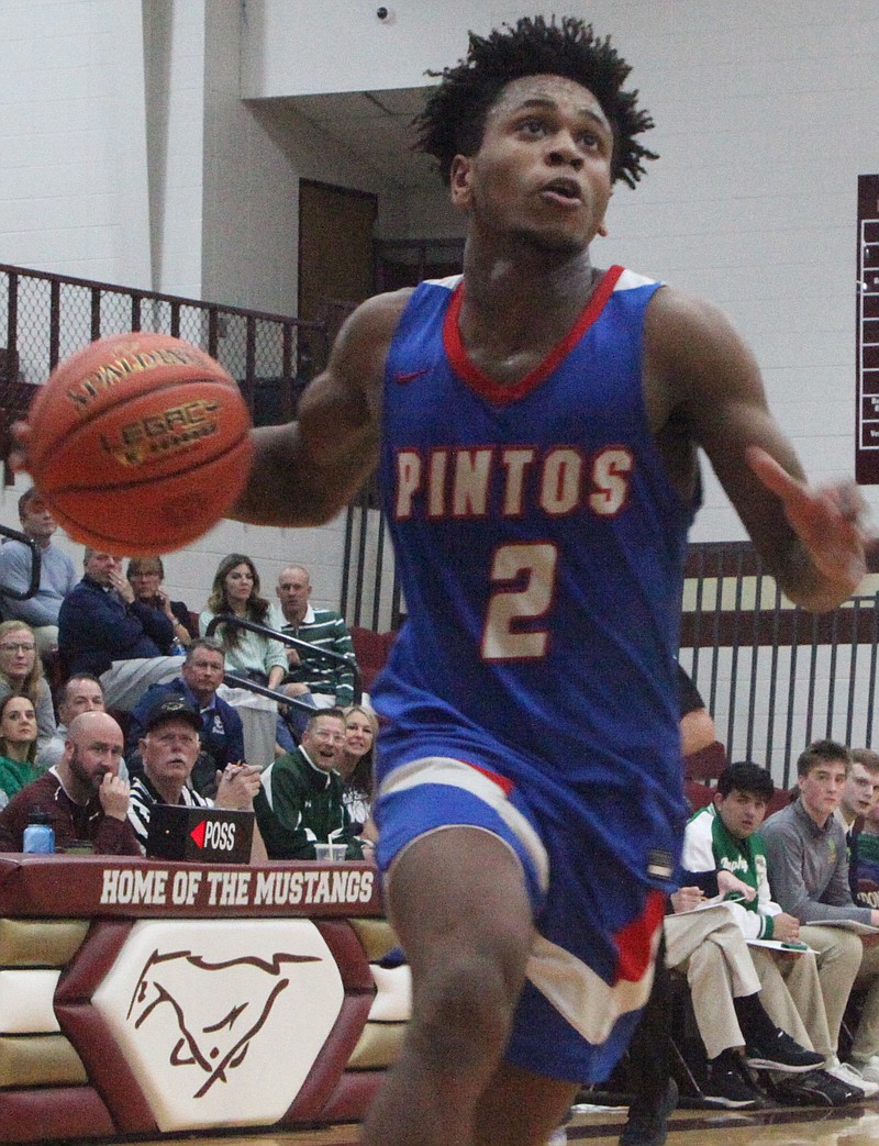 Junior guard Ayden Bryant breaks away for a layup against the Springfield Catholic Irish in the district semifinal. Bryant had nine points, four rebounds, three assists, and a steal on Wednesday. (Democrat photo/Evan Holmes)