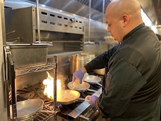 Chef Giovanni Lugo prepares a dish at Monjunis Italian Cafe & Grocery in Texarkana, Ark. (Staff photo by Sharda James)