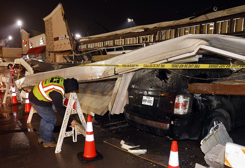 The roof of La Azteca grocery store on W. Eldorado Parkway peeled off and landed on a half dozen vehicles parked outside as a line of powerful thunderstorms rolled through Little Elm, Texas, on Thursday, March 2, 2023. (Tom Fox/The Dallas Morning News via AP)