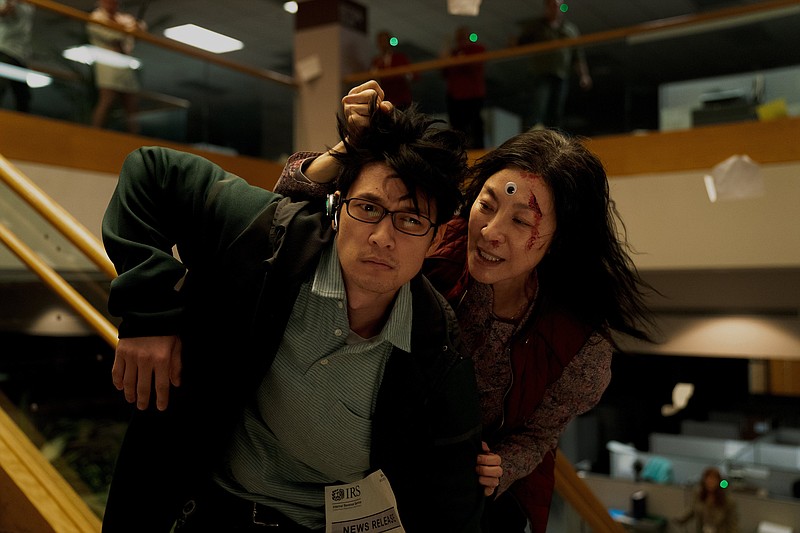 Michelle Yeoh (right) and Harry Shum Jr. star in “Everything Everywhere All at Once.” The film is a Best Picture nominee; Yeoh a Best Actress nominee. The 95th Academy Awards will be presented tonight.