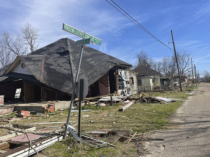 Debris litters the ground around homes heavily damaged by last month's tornado in Selma, Ala., Tuesday, Feb. 14, 2023. A month after a tornado ravaged historic Selma, a city etched in the history of the civil rights movement, residents and city officials say they are bracing for a long recovery.   (AP Photo/Kim Chandler)