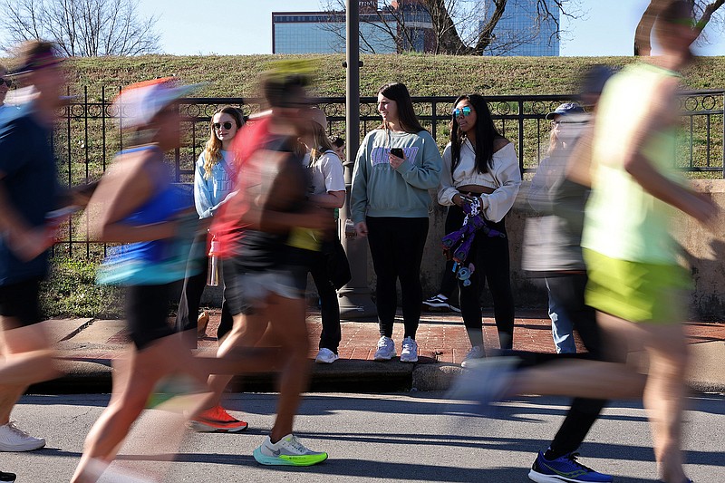 Supporters watch as runners go by during the North Little Rock leg of the Little Rock Marathon on Sunday, March 5, 2023. See more photos at arkansasonline.com/306marathon/ (Arkansas Democrat-Gazette/Colin Murphey)