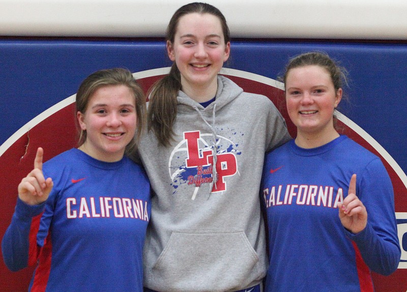 Despite losing in the district championship game on Saturday night, California seniors Ella Percival, Lauren Friedrich, and Alayna Butts celebrated their basketball careers after the game. (Democrat photo/Evan Holmes)