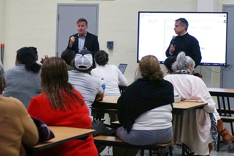 Catholic Legal Services' executive director Randy McGrorty, left, and staff attorney Miguel Mora talk to three dozen people interested in sponsoring relatives who want to come to the United States at a legal clinic hosted by St. Michael the Archangel Catholic Church, Wednesday, Feb. 15, 2023, in Miami. Many churches in the area are helping educate South Florida's large diaspora communities as well as new arrivals about legal migration options. (AP Photo/Giovanna Dell'Orto)