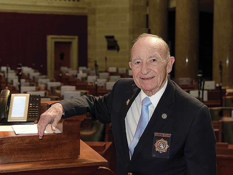 Julie Smith/News Tribune photo: 
Charlie Hildebrand poses at the dais in the Missouri House of Representatives, where he has served as a doorkeeper for 23 years.