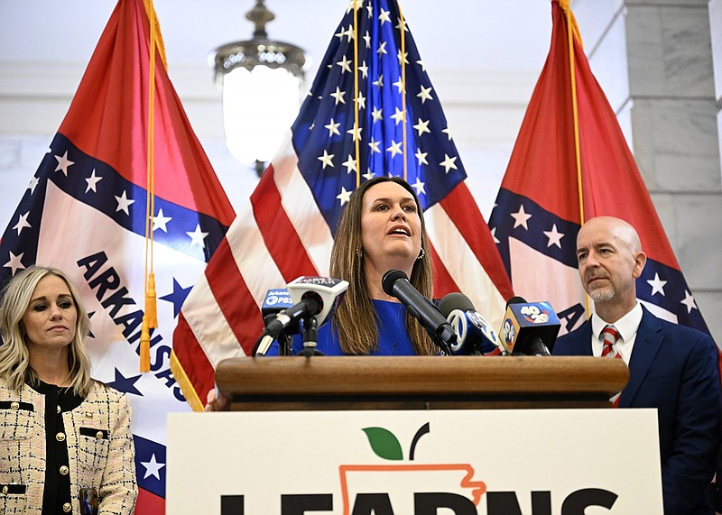 Governor Sarah Huckabee Sanders, center, addresses the media with Senator Breanne Davis, R-Russellville, left, and Secretary of Education Jacob Oliva during a signing ceremony for the LEARNS act on the second floor rotunda of the State Capitol on Wednesday, March 8, 2023.
(Arkansas Democrat-Gazette/Stephen Swofford)