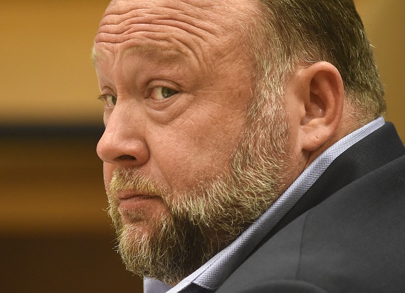 FILE - Infowars founder Alex Jones appears in court to testify during the Sandy Hook defamation damages trial at Connecticut Superior Court in Waterbury, Conn., Sept. 22, 2022. On Tuesday, March 7, 2023, Free Speech Systems, Jones' media company, proposed a plan in its bankruptcy case to pay the conspiracy theorist $520,000 a year while leaving $7 million to $10 million annually to pay off creditors, who include relatives of victims of the Sandy Hook school shooting. (Tyler Sizemore/Hearst Connecticut Media via AP, Pool, File)
