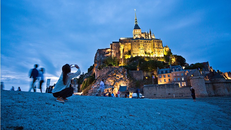 Christian pilgrims and tourists are drawn to the dramatically situated Mont St-Michel, a soaring island abbey in Normandy that is completely surrounded by the sea at high tide. (Rick Steves)