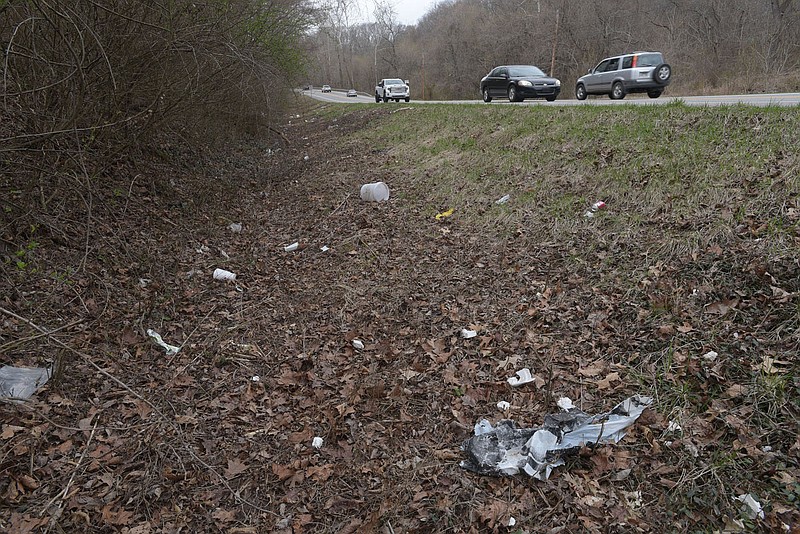 Drivers pass litter on March 7 2023 along Arkansas 12 in Rogers. The highway is one of several in Northwest Arkansas that could use a spring cleaning.
(NWA Democrat-Gazette/Flip Putthoff)